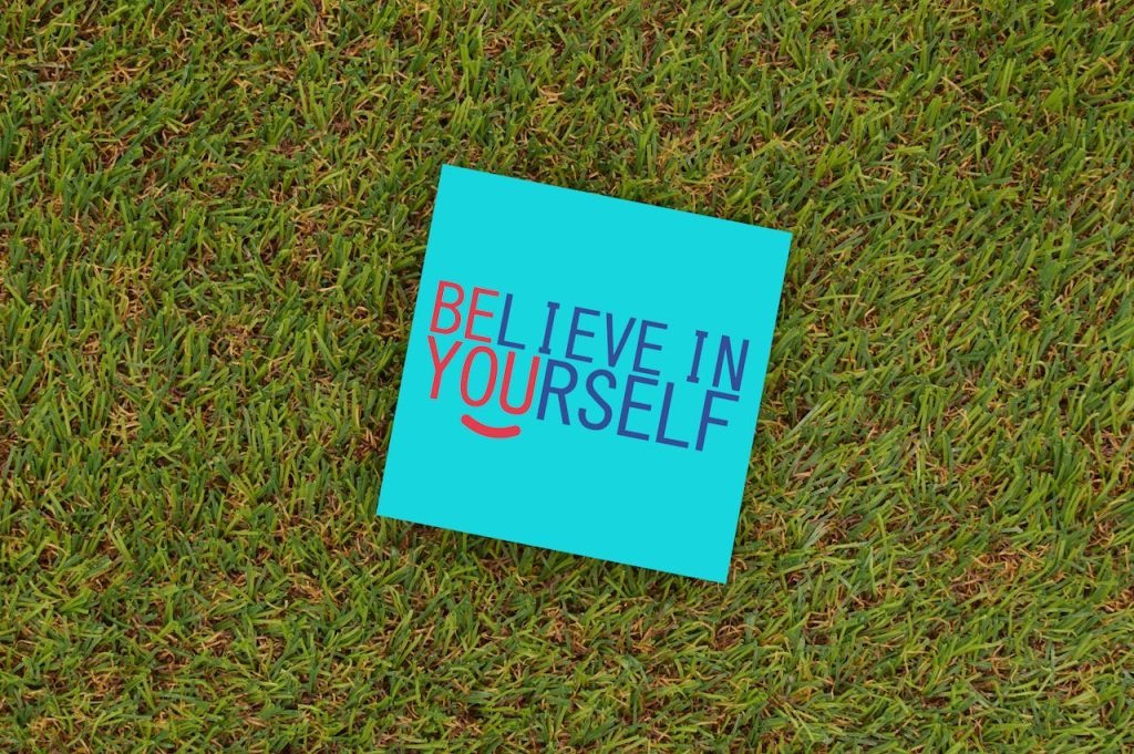 inspirational-message-on-turf-in-bright-colors-29570967 A vibrant note saying Believe in Yourself placed on green turf, capturing motivation and optimism.